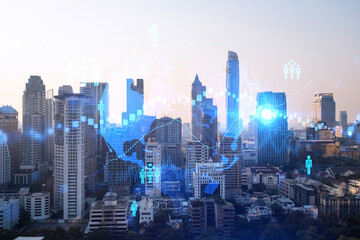 Hologram of social media icons over sunset panoramic cityscape of Bangkok, Asia. The concept of people connections. Multi exposure.