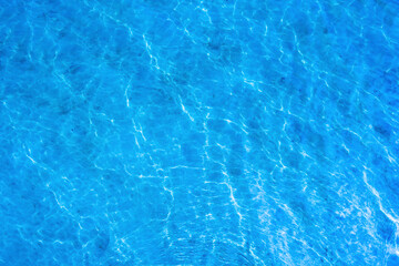 Texture of a blue water surface with light reflections