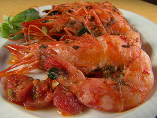 Shrimps in a salad on a white dish.