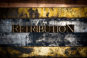 Photo of real authentic typeset letters forming Retribution of text on vintage textured silver grunge copper and gold background