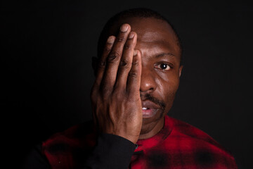 african man with hand on face stop racism