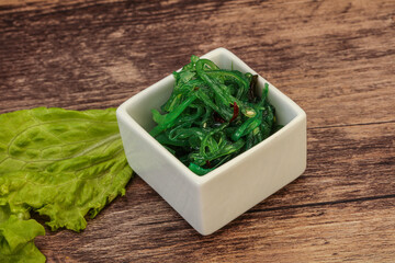 Green Chuka Seaweed Salad Isolated on White Background Top View. Wakame Sea Kelp Salat