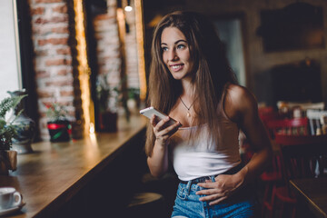 Woman using phone  in a cafe.