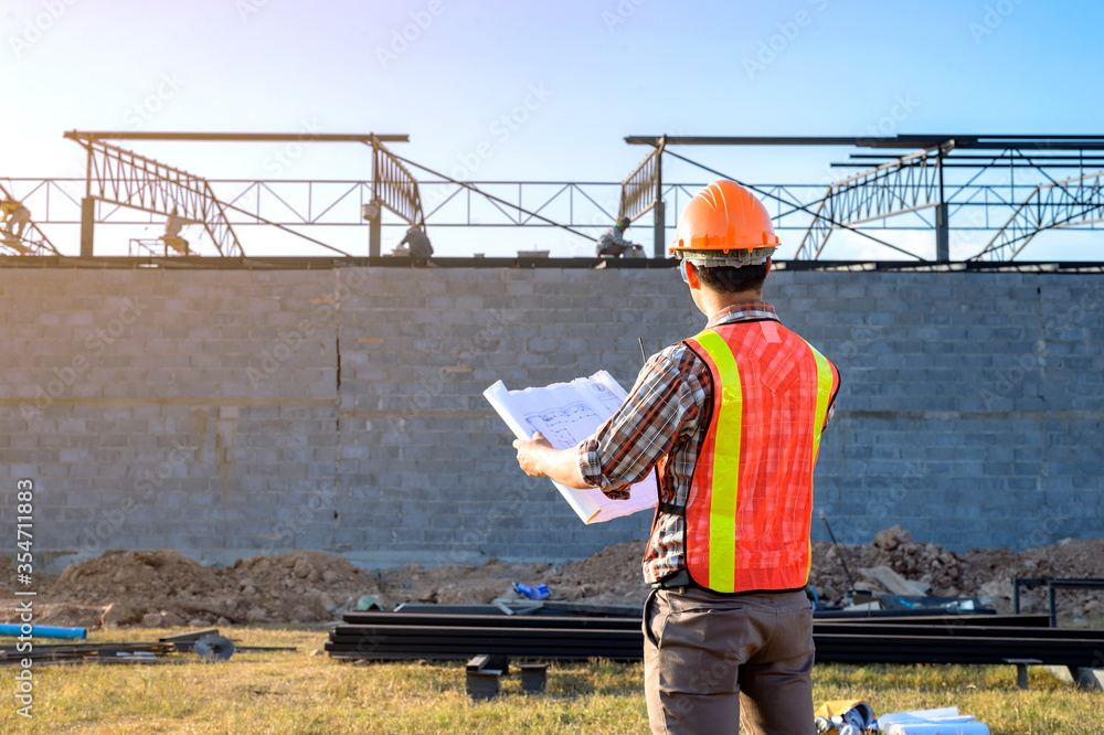 Poster engineer technician watching team of workers on high steel platform,engineer technician looking up a