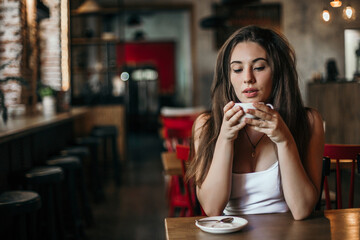 Beautiful woman drinking coffee sitting in a cafe.