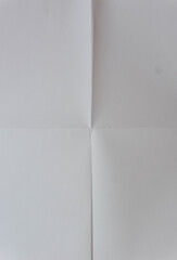 Whit paper texture. White paper sheet texture folded in four. White paper sheet folded in vertical and horizontal half.