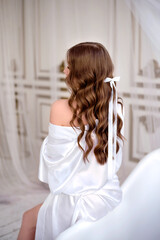 Portrait of a woman with long curly beautiful ginger hair.