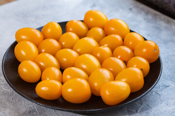 Tasty and healthy yellow ripe tomatoes on a plate