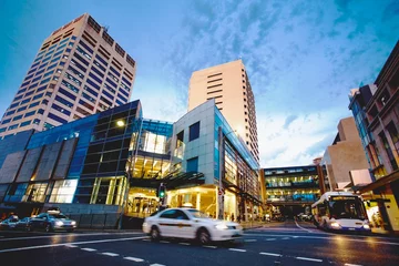 Rolgordijnen Bonbi junction crossroad, shopping center cityscape at sunset. Sydney, Australia © Francesca