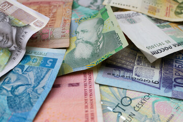 Pile of banknotes of eastern european currencies: Czech Koruna, Romanian Lei, Bosnian Convertible...