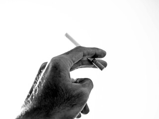 A cigarette in a hand - isolated on white background.