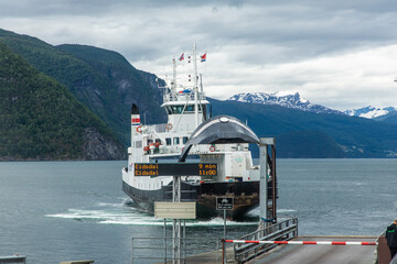 Ferry at the pier in a fjord of Alessund, Norway