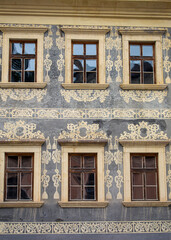 Vintage style old wooden windows with ornaments on the wall.Exterior of a building.