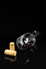 Fototapeta na wymiar red wine in a glass on a high leg on a black background