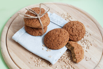 Oat cookies with oat grains on a circle wooden board