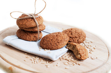Oat cookies with oat grains on a circle wooden board