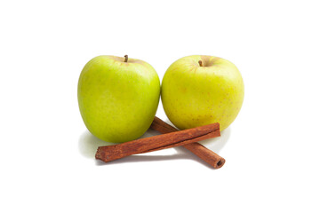 Two green apples and browm cinnamom sticks are on white background - perfecr aromatic pair