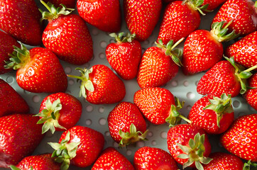 Ripe strawberries on a plate in the form of a pattern