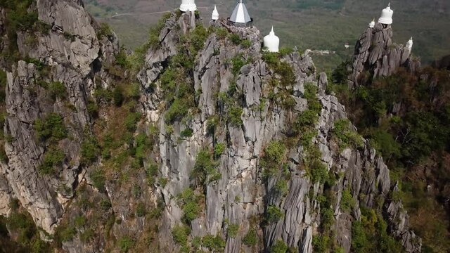 Thailand, Lampang Province. Tilt Up Aerial View of Wat Chaloem Phra Kiat Buddhist Temple on Mountain Hilltop