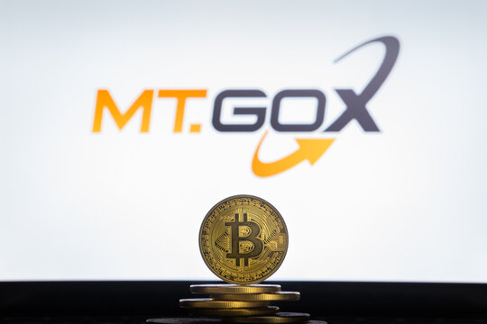 Bitcoin on a stack of coins with Mt.Gox logo on a laptop screen. Cryptocurrency and blockchain adoption concept. Slovenia, Ljubljana - 02 24 2019