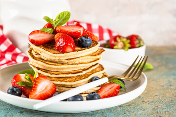 Pancakes with fresh berries and honey.