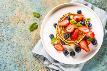 Pancakes with fresh berries and honey.