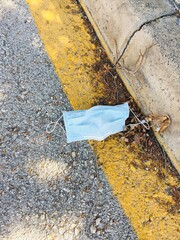 Medical face mask on the floor in the street.