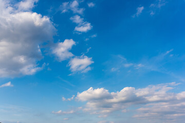 Beautiful blue summer sky with fluffy clouds as a background