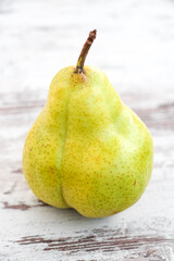 Pear on rustic wooden background. Yellow green pears. Day light. 