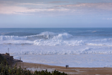 view of the beach with huge waves in Nazare