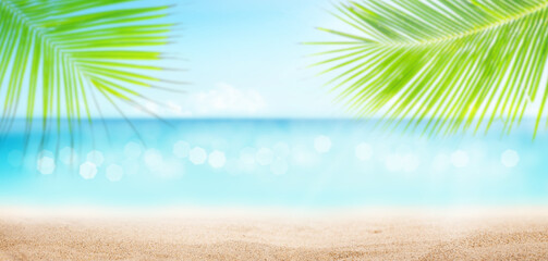 Fototapeta na wymiar Summer tropical sea with sparkling waves, sand and blue sunny sky