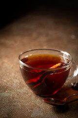Tea bag in a transparent glass cup with hot water