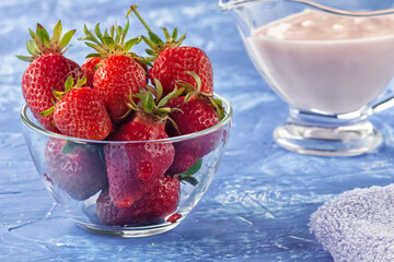 Fresh strawberries with freshly prepared yogurt on the table