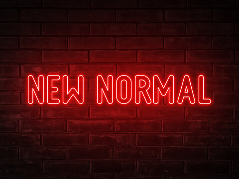 New normal - red neon light word on brick wall background
