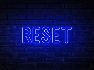 Fototapeta na wymiar Reset - blue neon light word on brick wall background