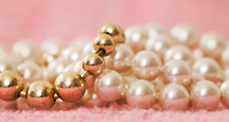 White and gold pearls, female gift jewelry necklace on pink background. Closeup, web banner.