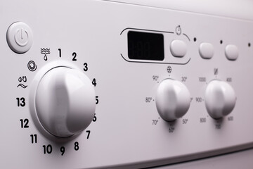 White washing machine control panel, selective focus