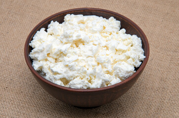 curd in brown bowl on sacking