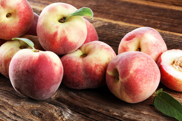 A group of ripe peaches on wooden table