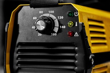 Inverter welding machine. Equipment for welding metals on a wooden desktop.