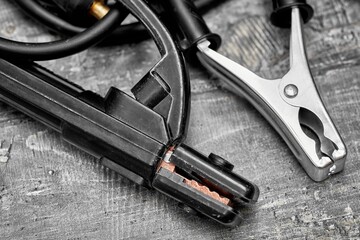 Inverter welding machine. Equipment for welding metals on a wooden desktop.