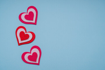 Red vertical hearts on a blue background. Copy space.