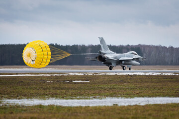 f16 fighter jet landing with open parachute in poland during presentation
