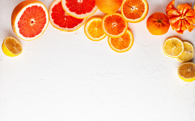 Assorted fresh citrus fruits on white background.Oranges, grapefruits, lemons,tangerines. Clean eating, healthy life. Top view.