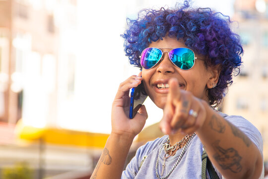 young girl with mobile phone and sunglasses in the city outdoors