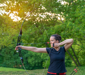 attractive sports woman in archery, arrows and bow in action