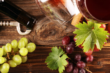 red Wine and white wine glass with grapes on rustic background