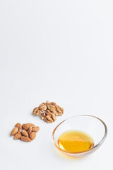 almonds and honey in a piala on a white background. healthy food. copy space for text