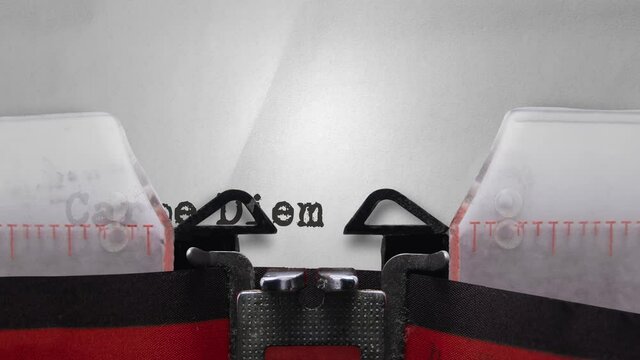 The Words Carpe Diem (Seize the Day) Being Typed On A Vintage Typewriter