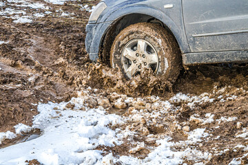 Fototapeta na wymiar Cars stuck in a field in the mud.